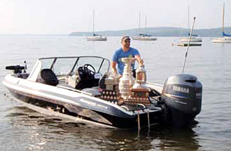 Tim Thomas posing for some photos with his hardware on Lake Champlain.